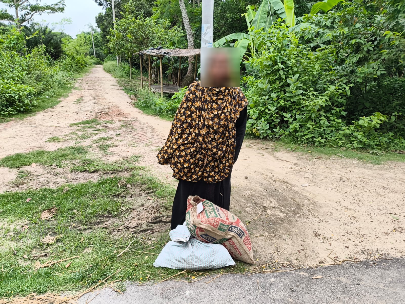 Community member carrying food aid home through rural Bangladesh