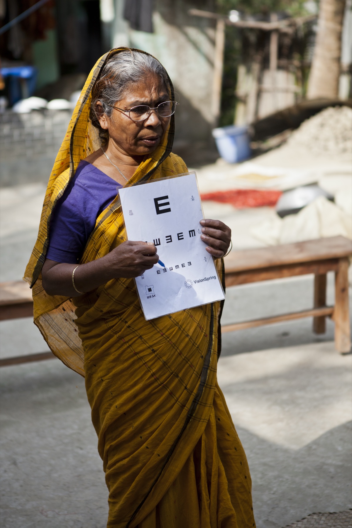 Woman receiving a vision test in a rural Bangladeshi village